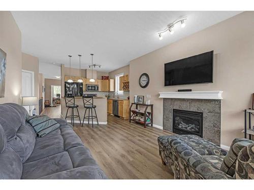 91 Evercreek Bluffs Place Sw, Calgary, AB - Indoor Photo Showing Living Room With Fireplace