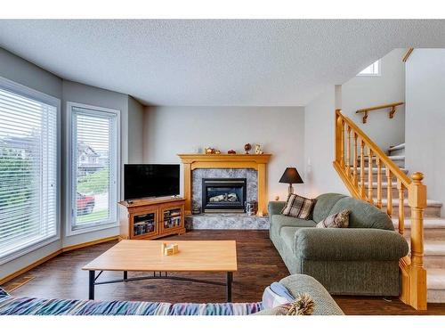 81 Bridlewood Manor Sw, Calgary, AB - Indoor Photo Showing Living Room With Fireplace
