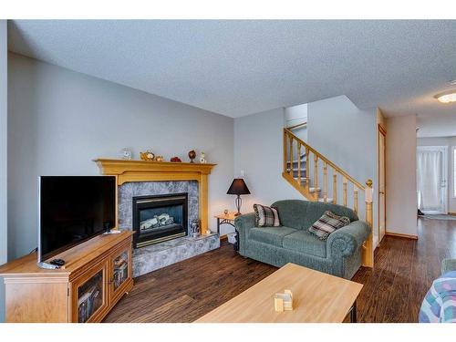81 Bridlewood Manor Sw, Calgary, AB - Indoor Photo Showing Living Room With Fireplace