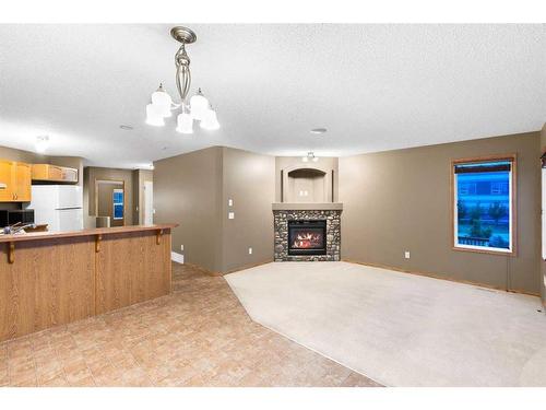8 Everridge Road Sw, Calgary, AB - Indoor Photo Showing Kitchen With Fireplace