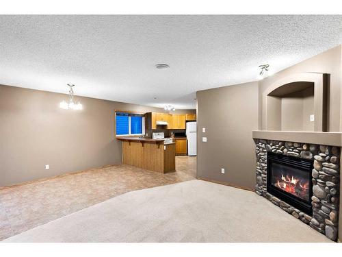 8 Everridge Road Sw, Calgary, AB - Indoor Photo Showing Living Room With Fireplace