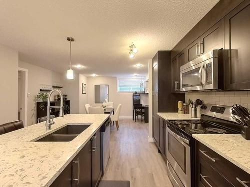 402 Cranford Mews Se, Calgary, AB - Indoor Photo Showing Kitchen With Double Sink With Upgraded Kitchen