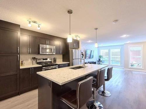 402 Cranford Mews Se, Calgary, AB - Indoor Photo Showing Kitchen With Stainless Steel Kitchen With Double Sink With Upgraded Kitchen