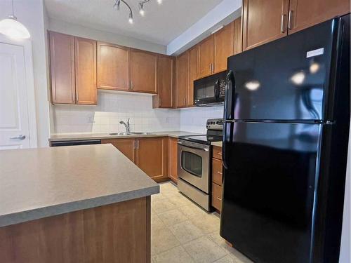 403-156 Country Village Circle Ne, Calgary, AB - Indoor Photo Showing Kitchen With Double Sink