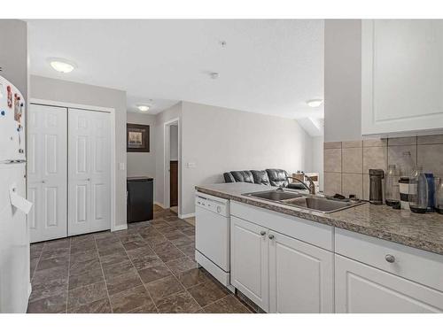 207-1010 Railway Street, Crossfield, AB - Indoor Photo Showing Kitchen With Double Sink