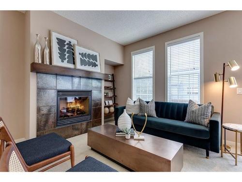 1303-155 Silverado Skies Link Sw, Calgary, AB - Indoor Photo Showing Living Room With Fireplace