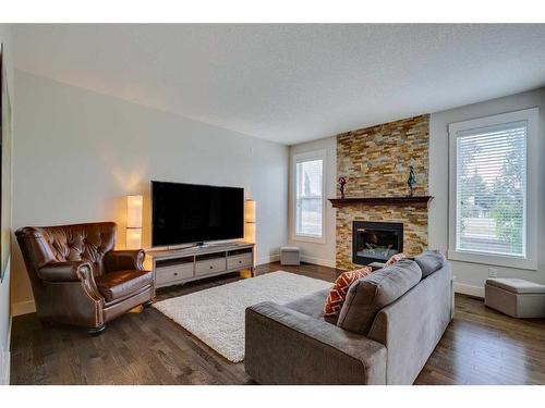 85 Aspenshire Crescent Sw, Calgary, AB - Indoor Photo Showing Living Room With Fireplace