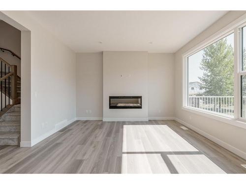 207 Silver Spruce Grove Sw, Calgary, AB - Indoor Photo Showing Living Room With Fireplace