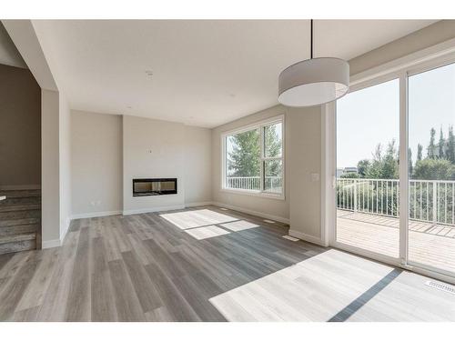 207 Silver Spruce Grove Sw, Calgary, AB - Indoor Photo Showing Other Room With Fireplace