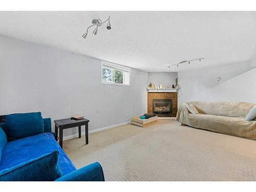 608 104 Avenue Sw, Calgary, AB - Indoor Photo Showing Living Room With Fireplace