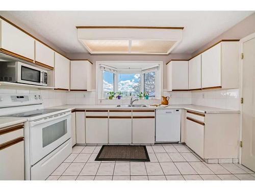 12132 Canfield Road Sw, Calgary, AB - Indoor Photo Showing Kitchen With Double Sink