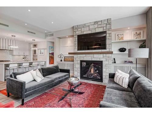 204-3030 17 Street Sw, Calgary, AB - Indoor Photo Showing Living Room With Fireplace