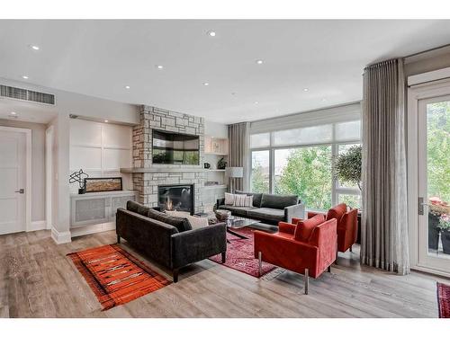 204-3030 17 Street Sw, Calgary, AB - Indoor Photo Showing Living Room With Fireplace