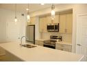 311-80 Carrington Plaza Nw, Calgary, AB  - Indoor Photo Showing Kitchen With Stainless Steel Kitchen With Double Sink With Upgraded Kitchen 