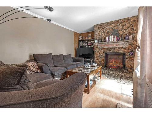 1802-2520 Palliser Drive Sw, Calgary, AB - Indoor Photo Showing Living Room With Fireplace