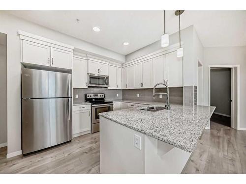 325-20 Seton Park Se, Calgary, AB - Indoor Photo Showing Kitchen With Stainless Steel Kitchen With Double Sink With Upgraded Kitchen