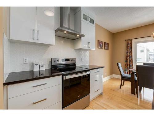 273 Cougartown Circle Sw, Calgary, AB - Indoor Photo Showing Kitchen With Fireplace With Double Sink