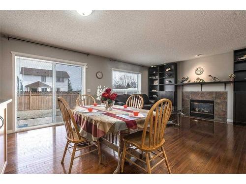 129 Millrise Square Sw, Calgary, AB - Indoor Photo Showing Dining Room With Fireplace