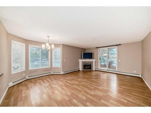 114-9 Country Village Bay Ne, Calgary, AB - Indoor Photo Showing Living Room With Fireplace