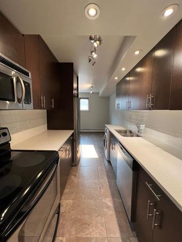 2-1230 Cameron Avenue Sw, Calgary, AB - Indoor Photo Showing Kitchen With Stainless Steel Kitchen With Double Sink