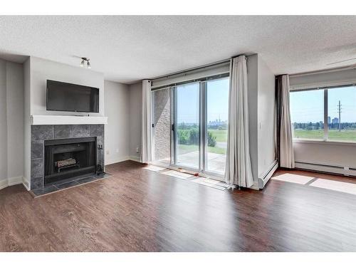 1-216 Village Terrace Sw, Calgary, AB - Indoor Photo Showing Living Room With Fireplace