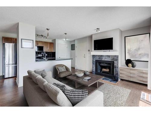 1-216 Village Terrace Sw, Calgary, AB - Indoor Photo Showing Living Room With Fireplace