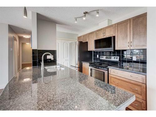 1-216 Village Terrace Sw, Calgary, AB - Indoor Photo Showing Kitchen With Stainless Steel Kitchen With Double Sink