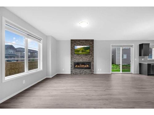 245 Carringham Way Nw, Calgary, AB - Indoor Photo Showing Living Room With Fireplace
