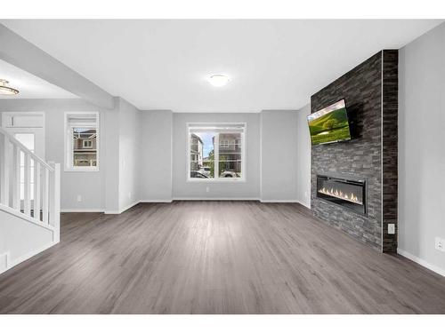 245 Carringham Way Nw, Calgary, AB - Indoor Photo Showing Living Room With Fireplace