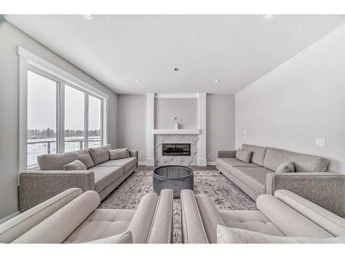 150 Sandpiper Park, Chestermere, AB - Indoor Photo Showing Living Room With Fireplace