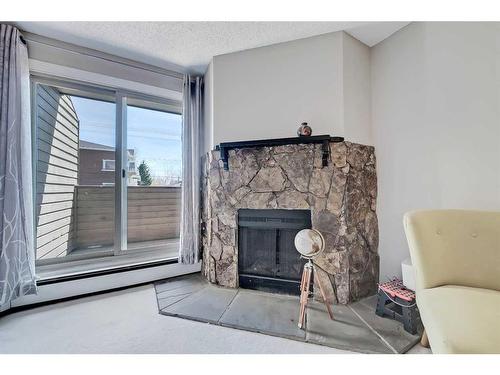 208-2218 30 Street Sw, Calgary, AB - Indoor Photo Showing Living Room With Fireplace