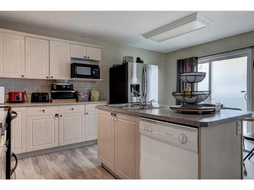 137 Bridleridge Circle Sw, Calgary, AB - Indoor Photo Showing Kitchen With Double Sink