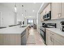 411-40 Carrington Plaza Nw, Calgary, AB  - Indoor Photo Showing Kitchen With Stainless Steel Kitchen With Double Sink With Upgraded Kitchen 