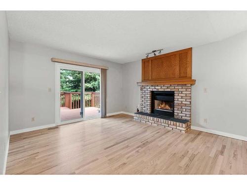 1046 Suncastle Drive Se, Calgary, AB - Indoor Photo Showing Living Room With Fireplace