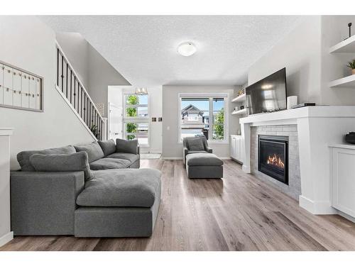 23 Belmont Gardens Sw, Calgary, AB - Indoor Photo Showing Living Room With Fireplace