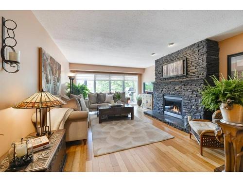 18-1220 Prominence Way Sw, Calgary, AB - Indoor Photo Showing Living Room With Fireplace