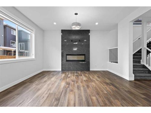 113 Amblehurst Rise Nw, Calgary, AB - Indoor Photo Showing Living Room With Fireplace