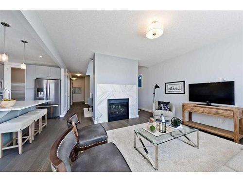 27 Versant View Sw, Calgary, AB - Indoor Photo Showing Living Room With Fireplace
