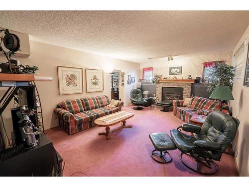 279 Shawinigan Drive Sw, Calgary, AB - Indoor Photo Showing Living Room With Fireplace