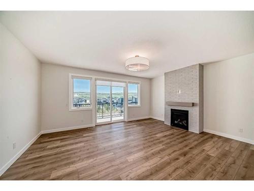 205 Precedence View, Cochrane, AB - Indoor Photo Showing Living Room With Fireplace