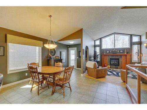 14 Cresthaven View Sw, Calgary, AB - Indoor Photo Showing Dining Room With Fireplace