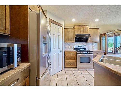 208 Tuscany Ridge Crescent Nw, Calgary, AB - Indoor Photo Showing Kitchen With Double Sink