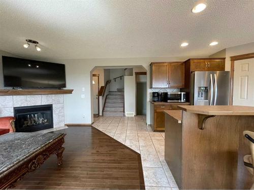 208 Tuscany Ridge Crescent Nw, Calgary, AB - Indoor Photo Showing Kitchen With Fireplace