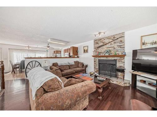 12 West Heights Drive, Didsbury, AB - Indoor Photo Showing Living Room With Fireplace