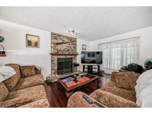 12 West Heights Drive, Didsbury, AB - Indoor Photo Showing Living Room With Fireplace