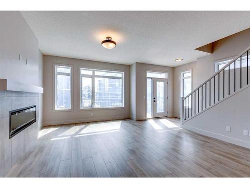 57 Royal Elm Green Nw, Calgary, AB - Indoor Photo Showing Living Room With Fireplace