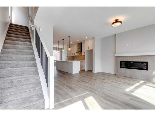 57 Royal Elm Green Nw, Calgary, AB - Indoor Photo Showing Living Room With Fireplace