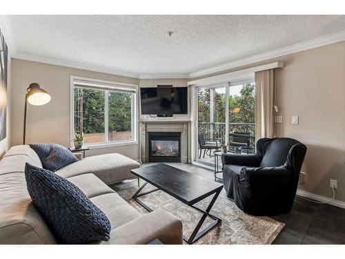 202-736 57 Avenue Sw, Calgary, AB - Indoor Photo Showing Living Room With Fireplace