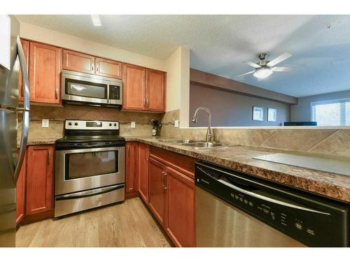 2208-5200 44 Avenue Ne, Calgary, AB - Indoor Photo Showing Kitchen With Stainless Steel Kitchen With Double Sink