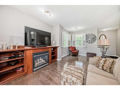 62 Discovery Heights Sw, Calgary, AB - Indoor Photo Showing Living Room With Fireplace